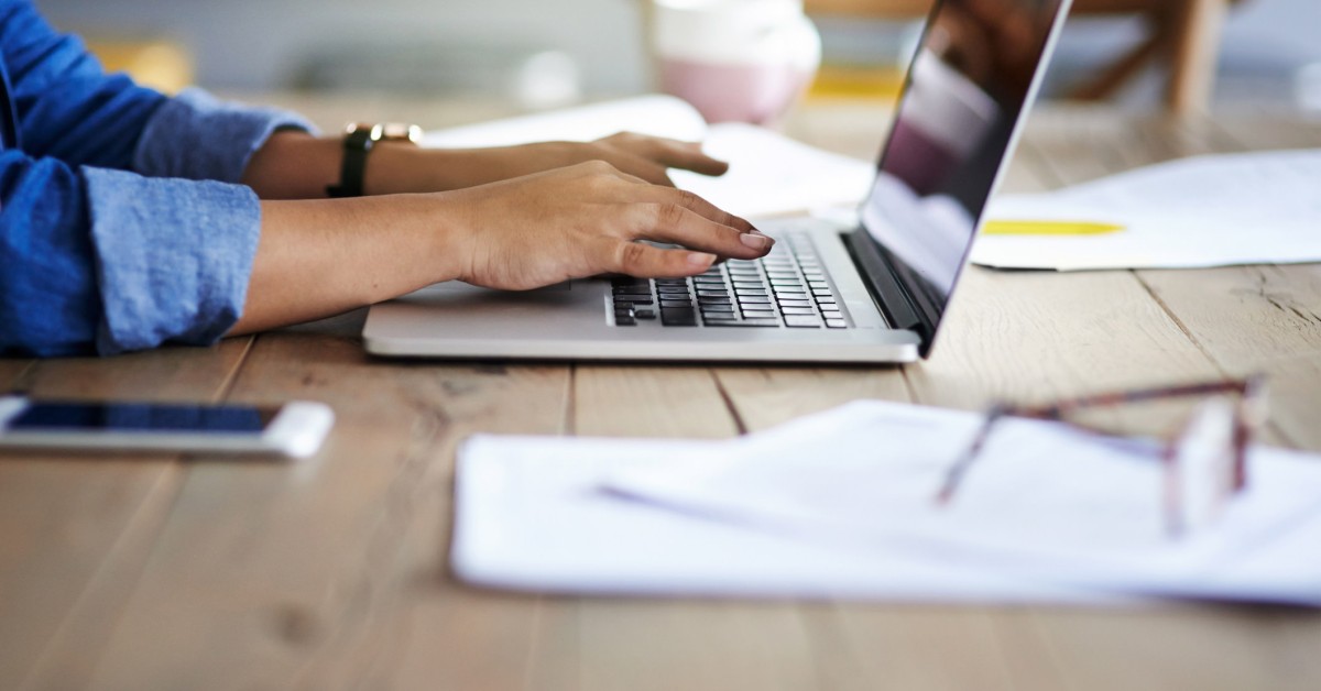 Photo of a person working on a laptop