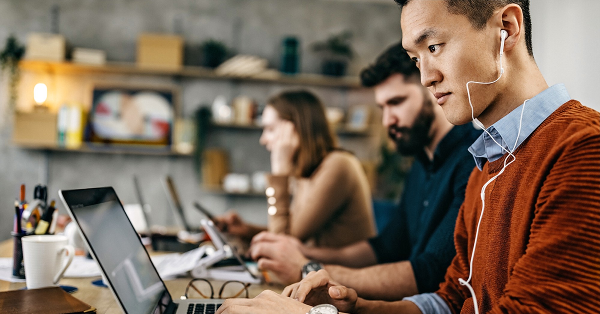 Man doing work on a laptop in an office setting