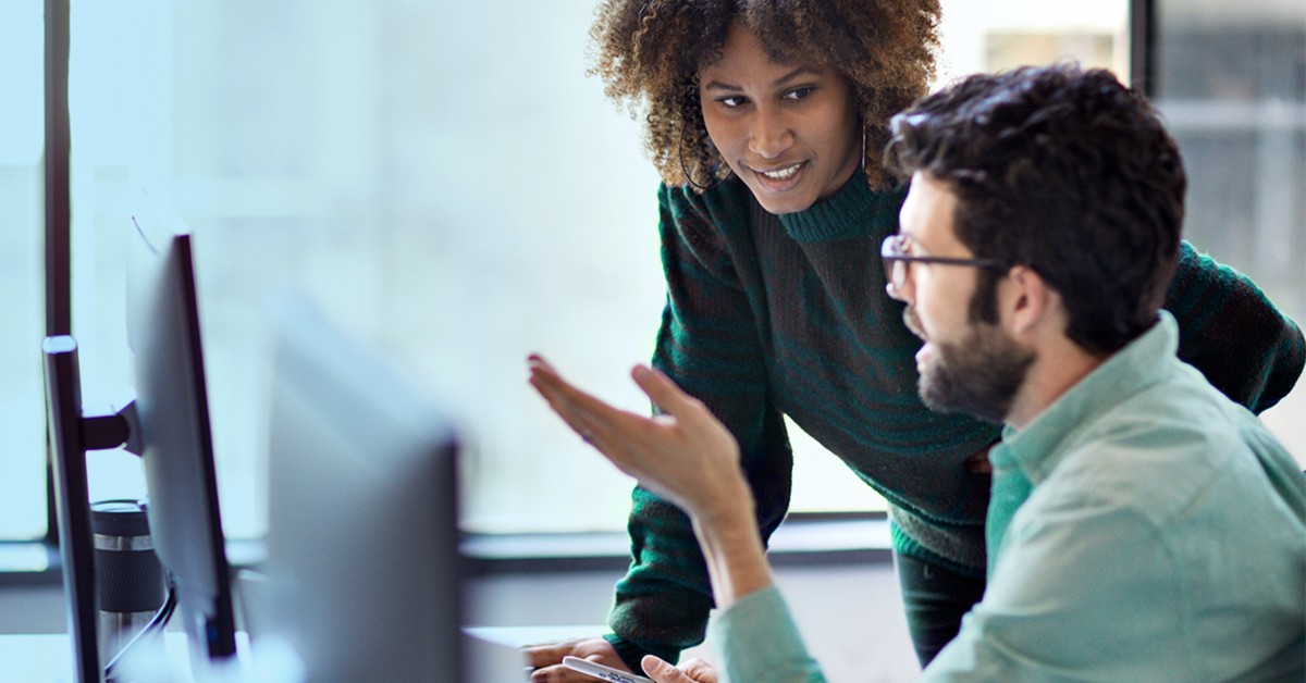 two people working together at a computer