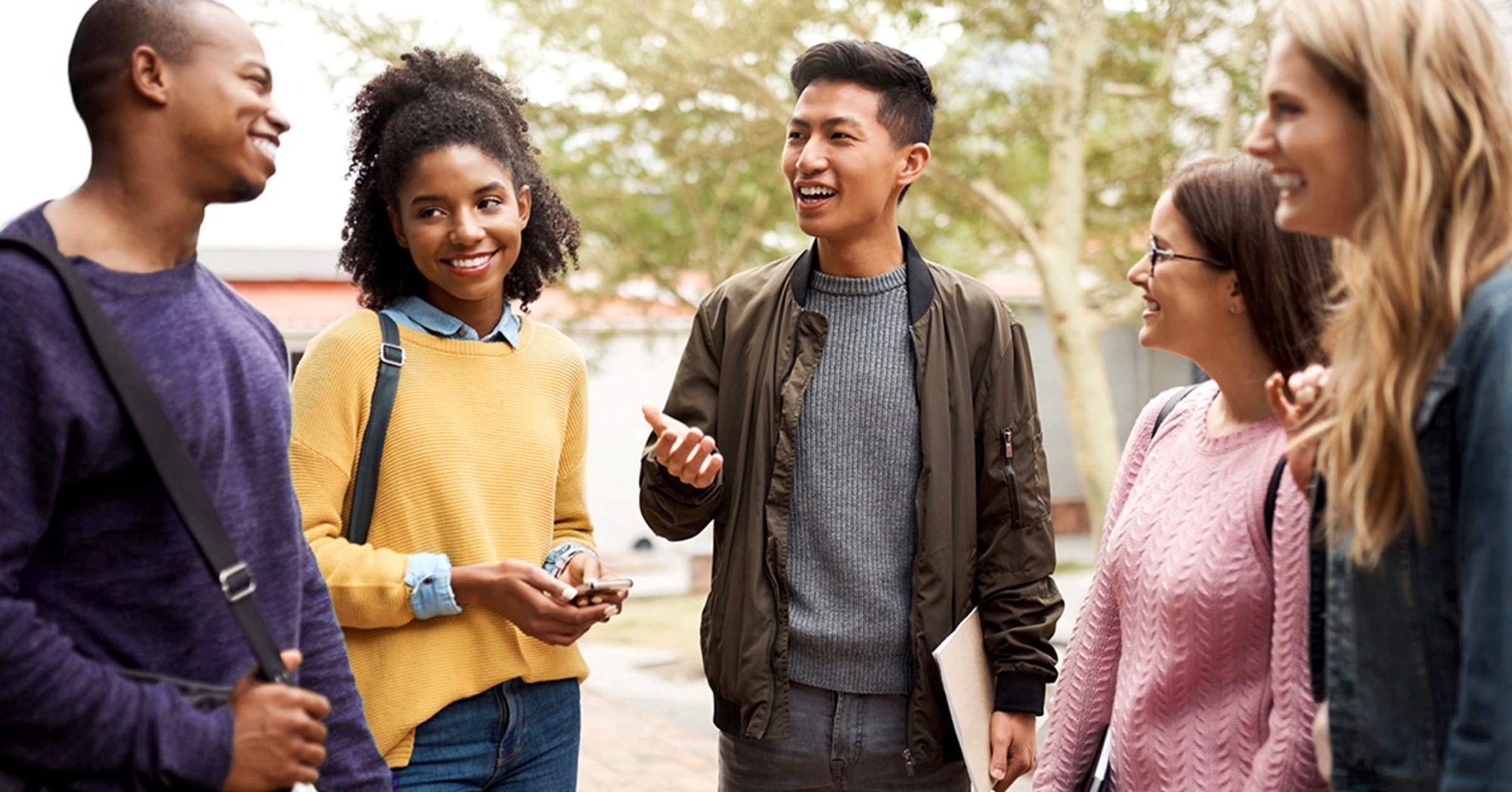 Students standing outside having a conversation 