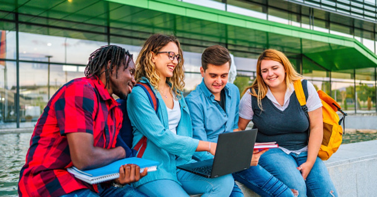 students collaborating together on a laptop