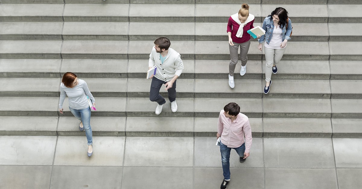 Aerial photo of student walking down stairs on campus