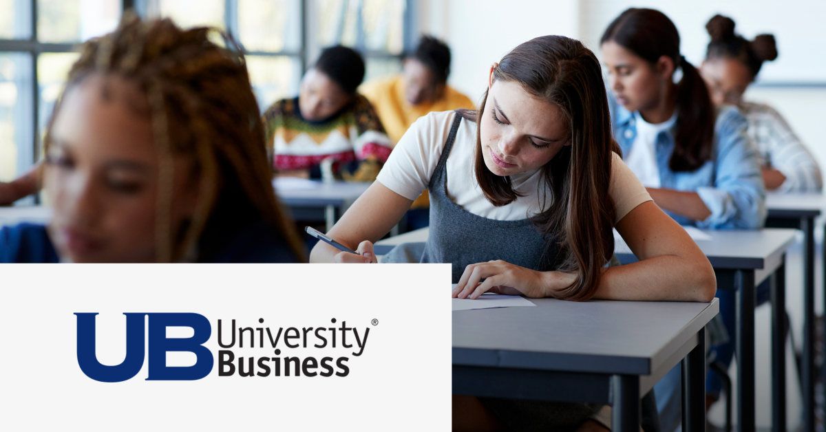 Image of a group of students writing on their notebooks in a classroom. On the lower left corner is placed the University Business logo. 