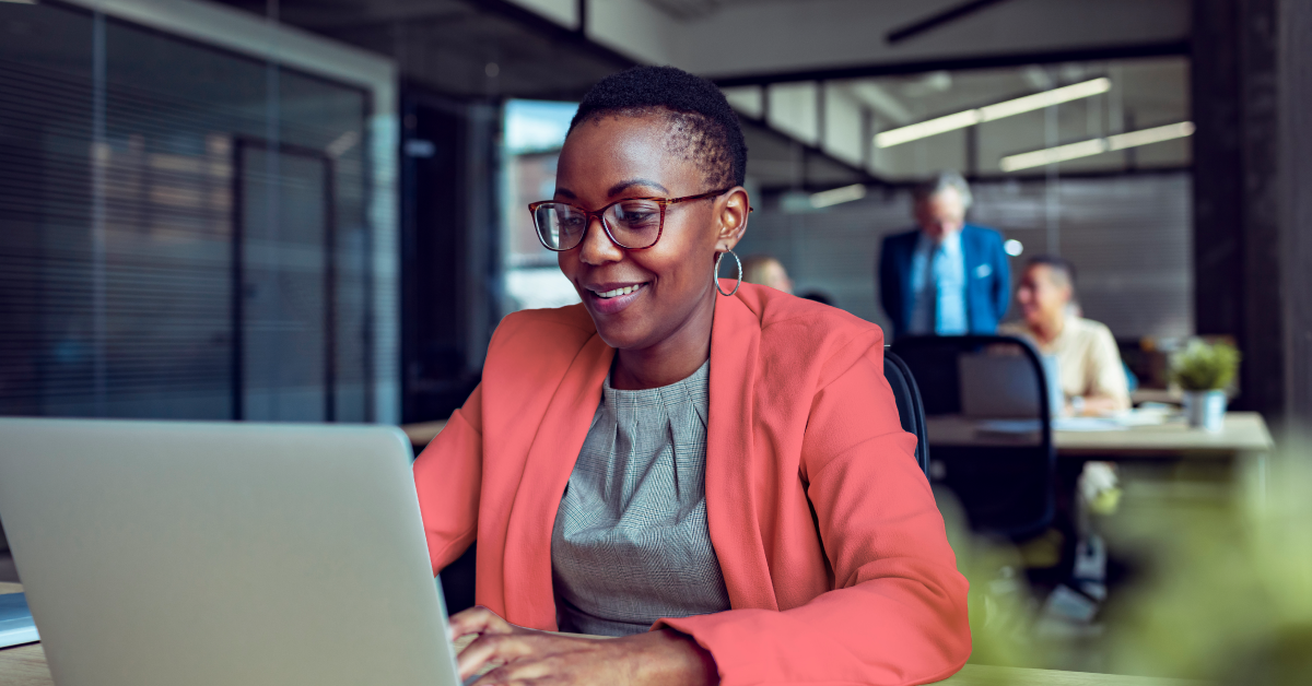 woman working on a laptop in office setting